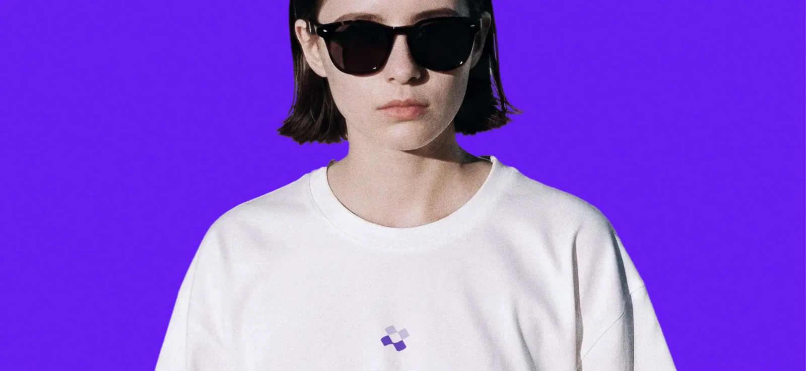 A white T-shirt with a small Lodol symbol on the chest, on an Electric Indigo background.